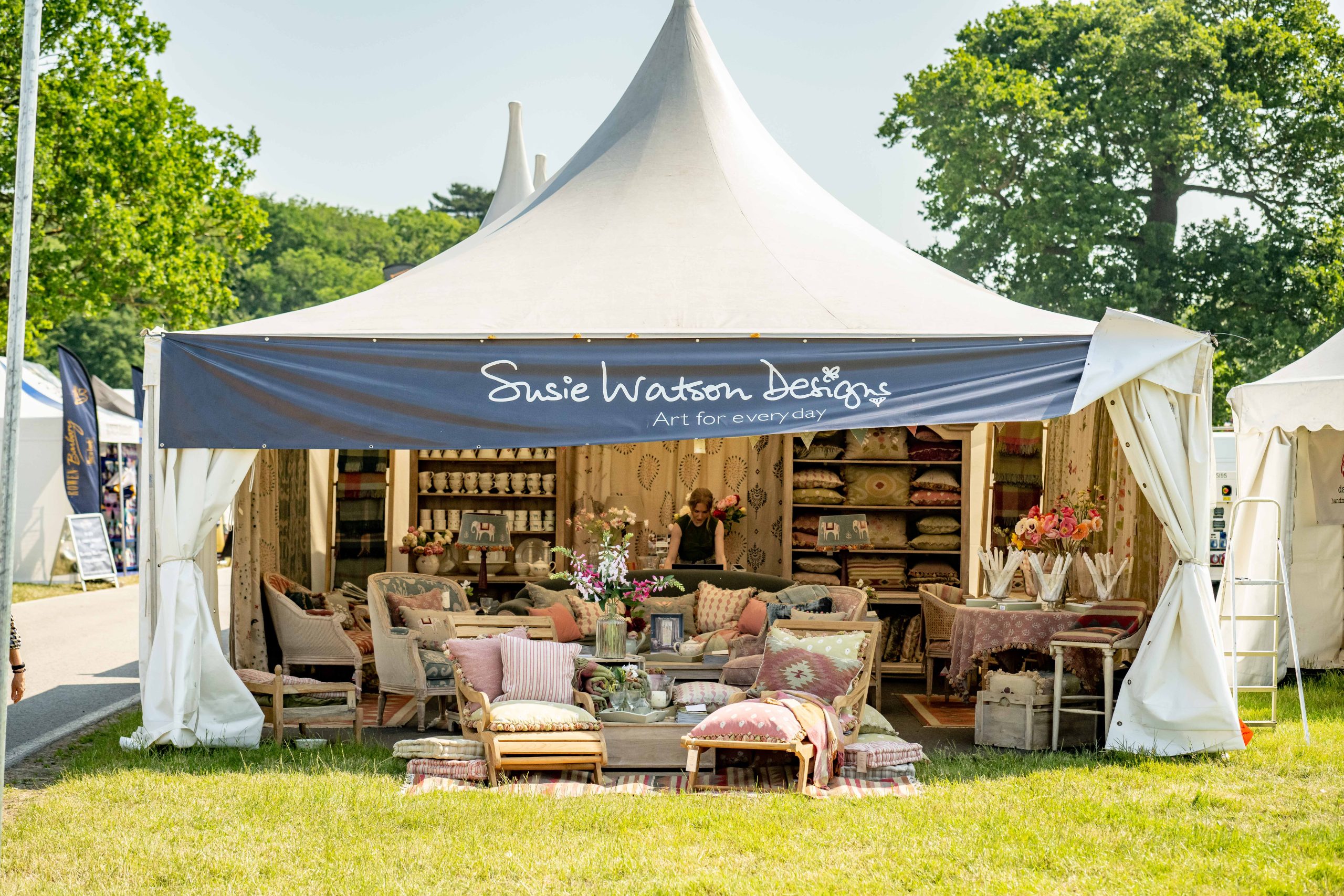 Susie Watson Designs trade stand at Bolesworth International, showcasing home furnishings, decorative ornaments and furniture.