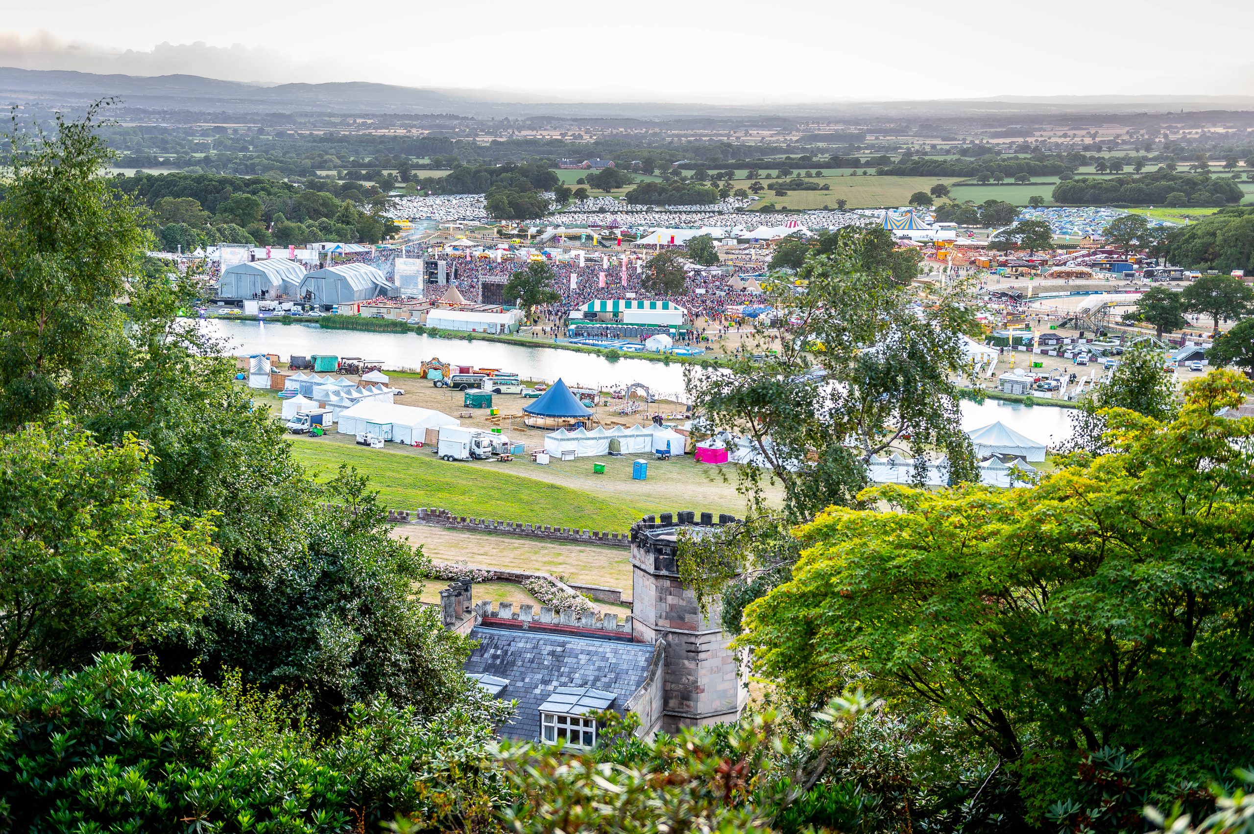 Aerial view of the Bolesworth grounds during the international event, showcasing trade stands, show grounds, hospitality tents, large crowds, parking areas, and the Bolesworth estate.
